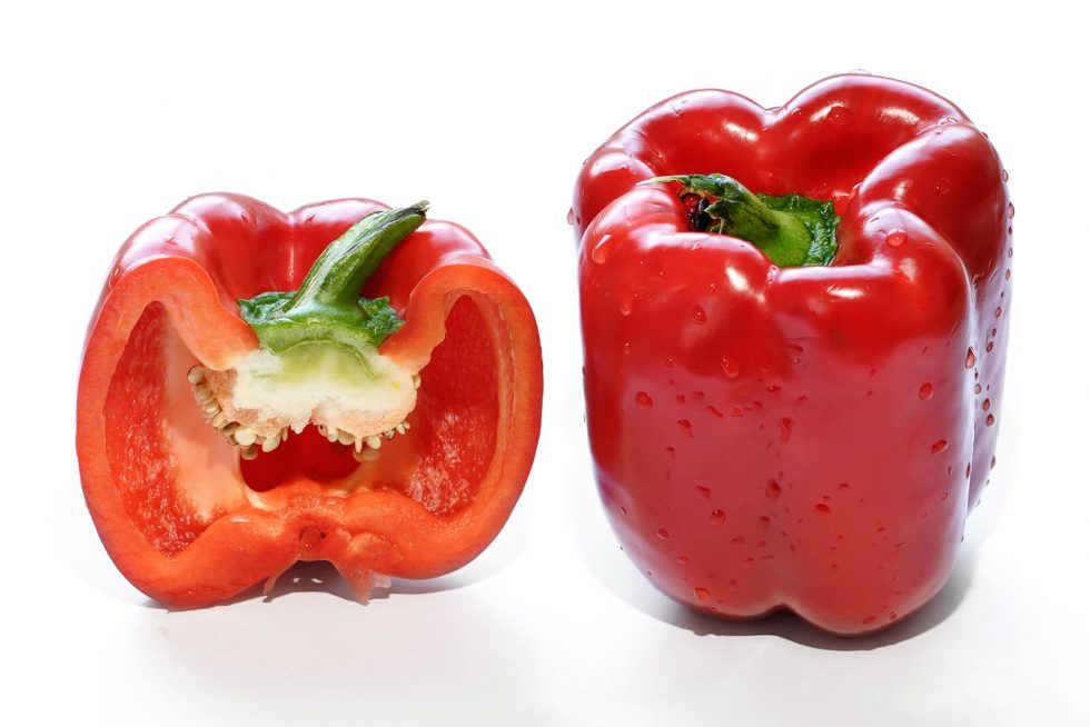 one red capsicum and a cross-section